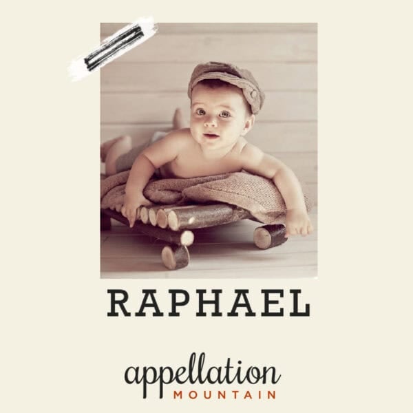 baby boy wearing brown tweed newsboy cap sitting on brown towel on wooden pallet; baby name Raphael