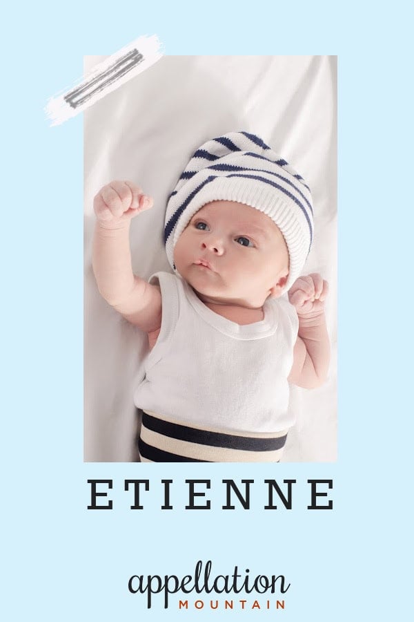 baby boy on white sheet wearing blue white stripe hat, white top and blue/white stripe bottoms; baby name Etienne