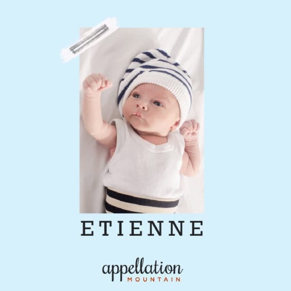 baby boy on white sheet wearing blue white stripe hat, white top and blue/white stripe bottoms; baby name Etienne