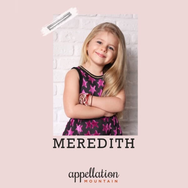girl child with long blonde hair wearing dark purple dress with purple stars; baby name Meredith