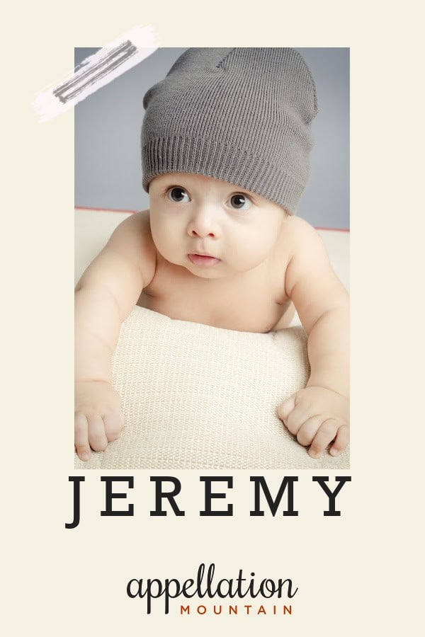 baby wearing gray knit hat propped up on cream cushion; baby name Jeremy
