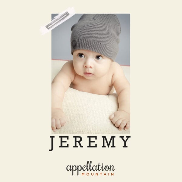baby wearing gray knit hat propped up on cream cushion; baby name Jeremy