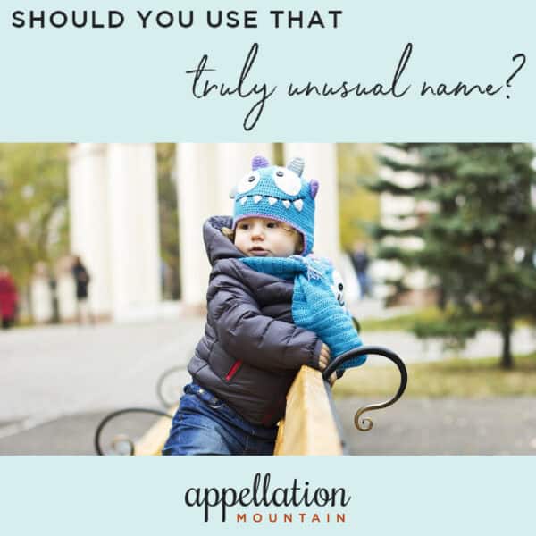 baby wearing monster hat standing on bench outdoors in urban area; unusual names