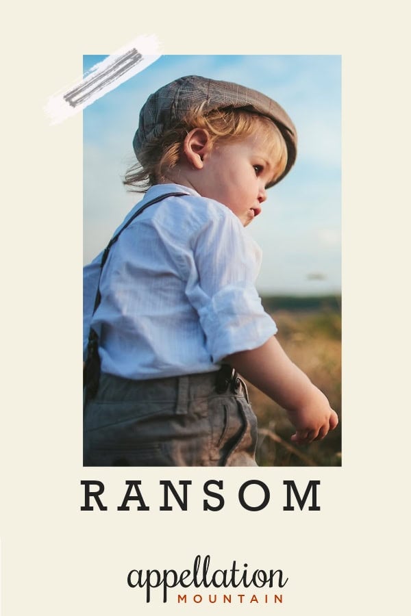 baby boy wearing old fashioned hat, suspenders, and white shirt standing in field; baby name Ransom