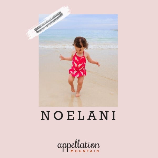 toddler girl in red swimsuit walking on beach; baby name Noelani