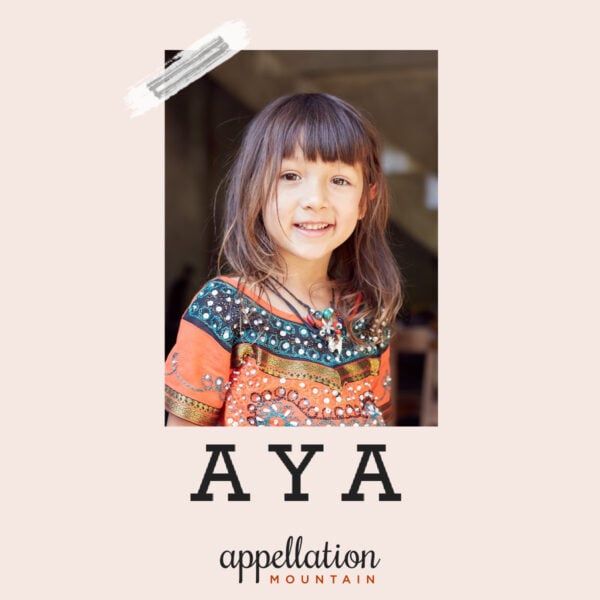 young girl child with shoulder length brown hair and very colorful dress; baby name Aya