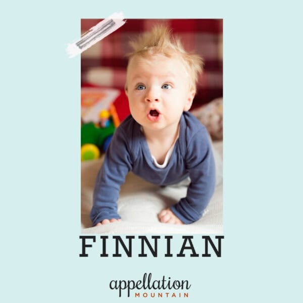 baby boy with tuft of red-blonde hair wearing blue shirt pushed up on his arms; baby name Finnian