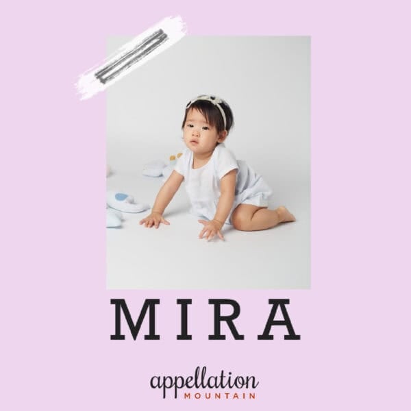 toddler girl of Asian descent wearing white outfit and headband; baby name Mira