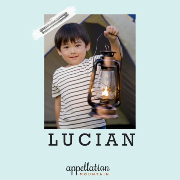 toddler boy wearing striped shirt holding a lantern; baby name Lucian