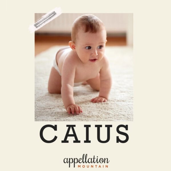baby boy crawling on white carpet wearing diaper; baby name Caius