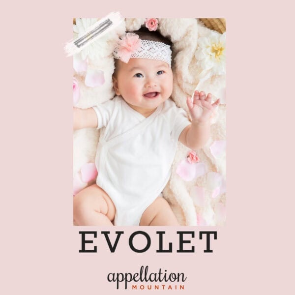 baby girl with dark hair wearing headband and white onesie laying on blanket; baby name Evolet