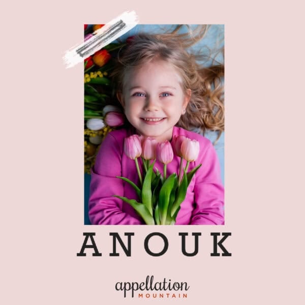 girl child with long hair wearing pink top and holding pink tulips; baby name Anouk