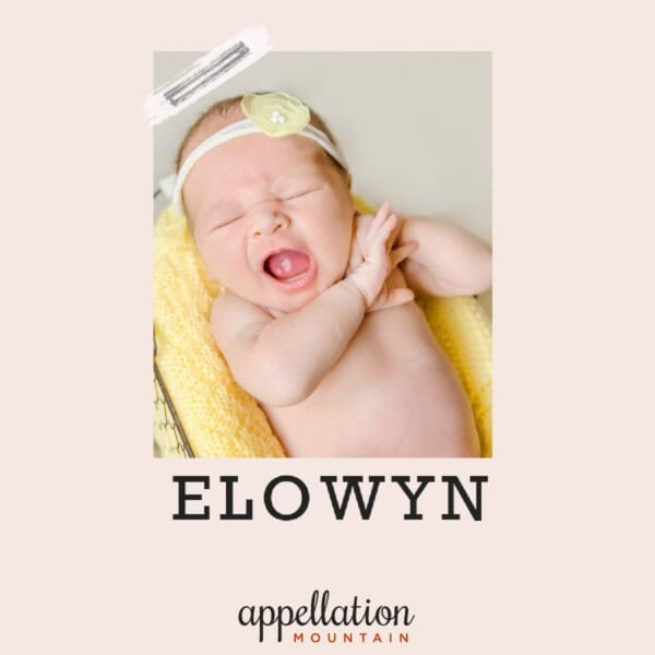 baby girl wearing headband on yellow blanket; baby name Elowyn
