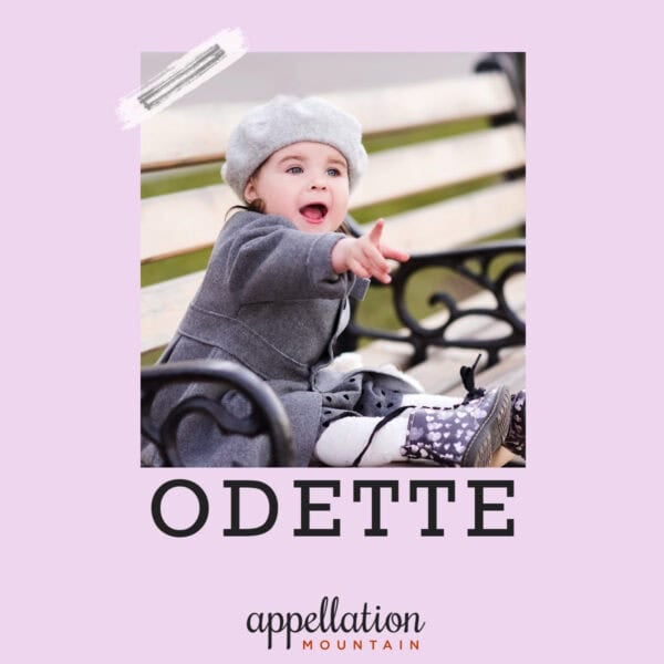 baby girl sitting on bench wearing beret, gray jacket, and rain boots; baby name Odette