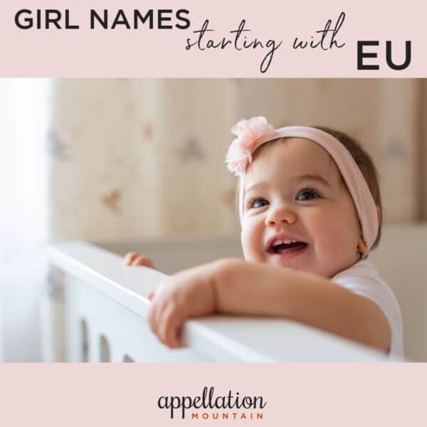 baby girl with pink headband standing against white crib railing; good girl names starting with EU