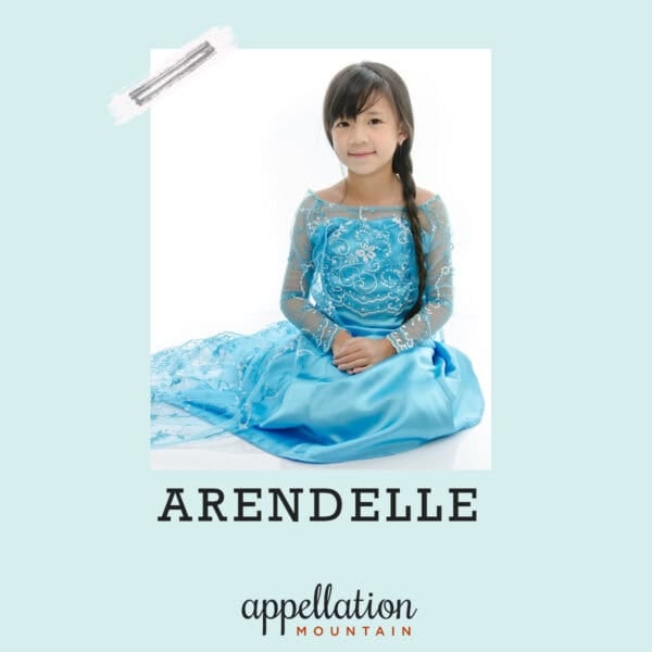 dark-haired young girl sitting on floor wearing Elsa/Frozen style dress with hair in a braid; baby name Arendelle