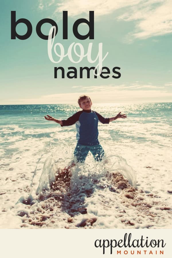 boy child standing in rushing ocean surf; bold boy names like Jax