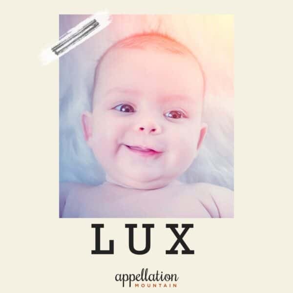 infant face close-up with sunlight filtering in top corner; baby name Lux