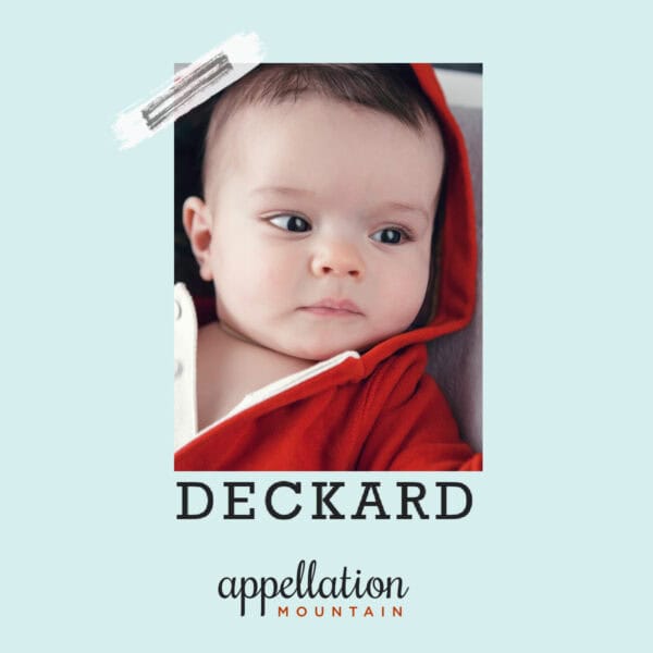 baby with dark hair wrapped in dark red hoodie; text reads "Deckard"