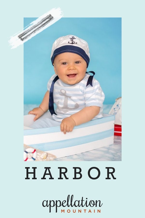 baby in sailor hat and nautical outfit with blue striped boat; baby name Harbor