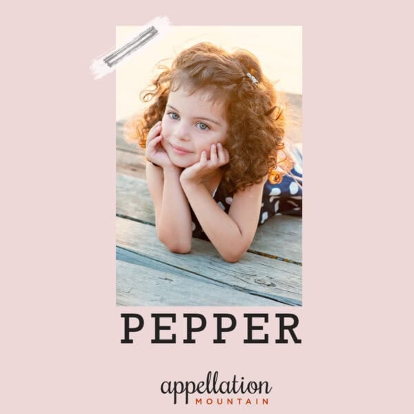 girl child with auburn curly hair, face propped up on elbows, baby name Pepper