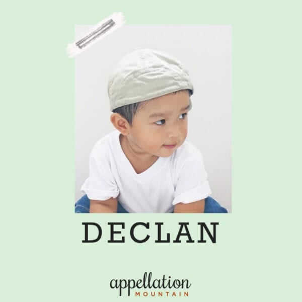 boy wearing backward baseball cap, white tee, jeans, baby name Declan