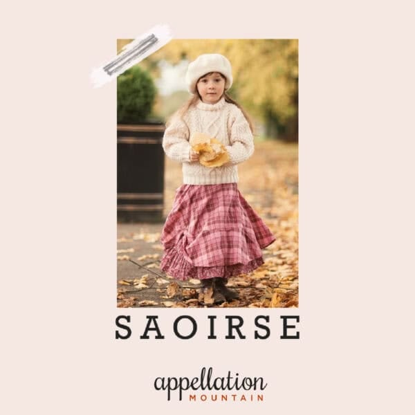 girl child wearing long plaid skirt, knit sweater and hat walking in autumn leaves; baby name Saoirse