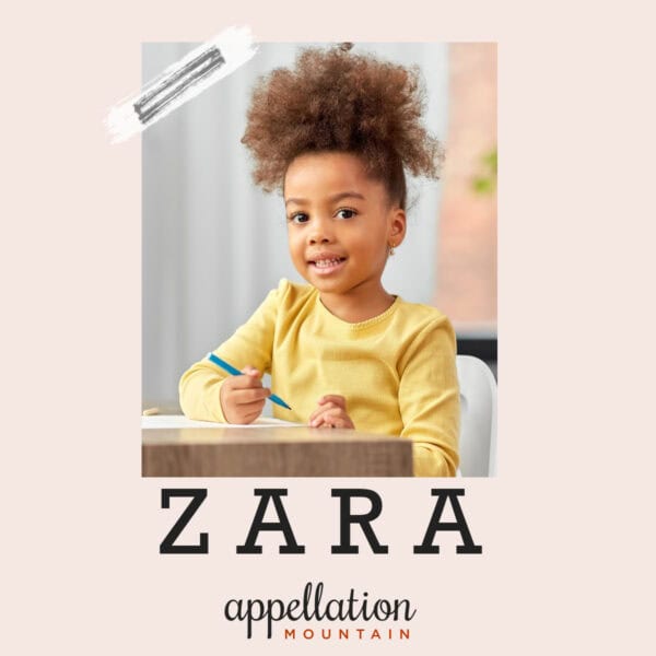 African American girl wearing yellow long-sleeved shirt, sitting at table writing, Baby Name of the Day Zara