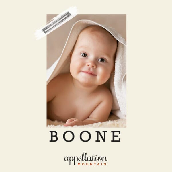 baby with off white blanket draped over him; baby name Boone