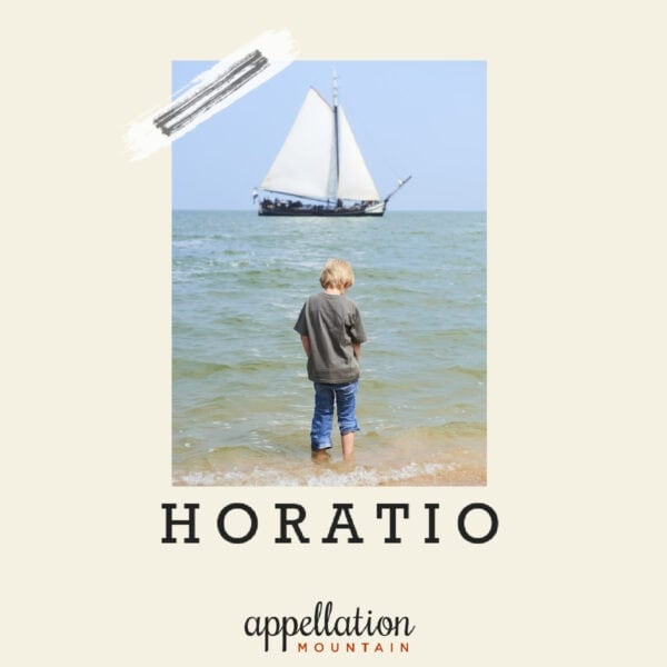 toddler boy with blonde hair wading into the ocean with sailing ship ahead; "baby name Horatio"