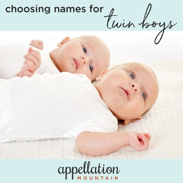 twin babies wearing white onesies laying on their backs; naming twin boys