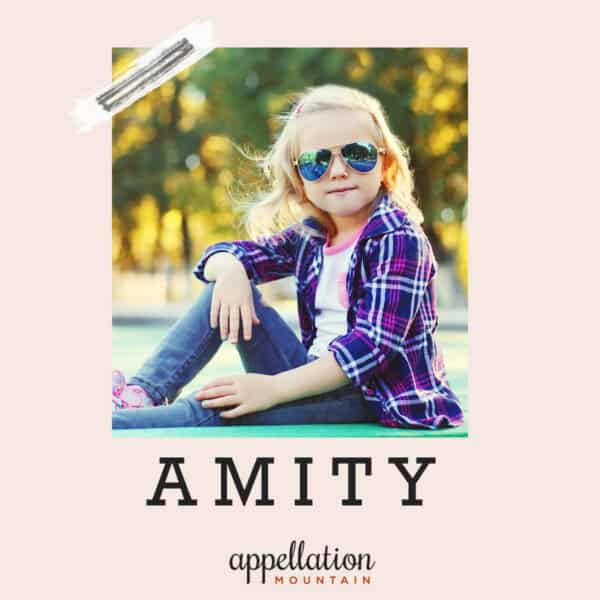 blonde girl child wearing blue plaid shirt and sunglasses with jeans; baby name Amity