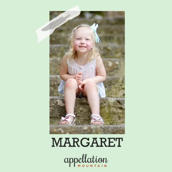 blonde child wearing sundress and sandals sitting on steps; baby name Margaret