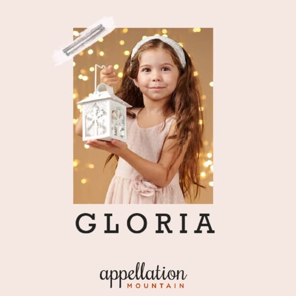 girl child with long brown hair wearing light pink dress and headband holding white lantern on starry gold background; baby name Gloria
