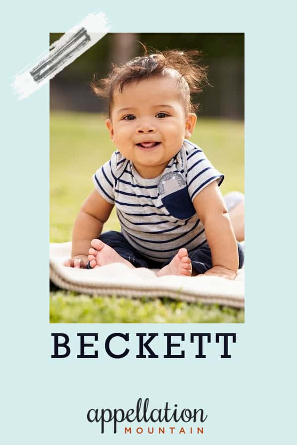 boy child with wispy dark hair wearing navy and white striped top sitting outside on a blanket; baby name Beckett
