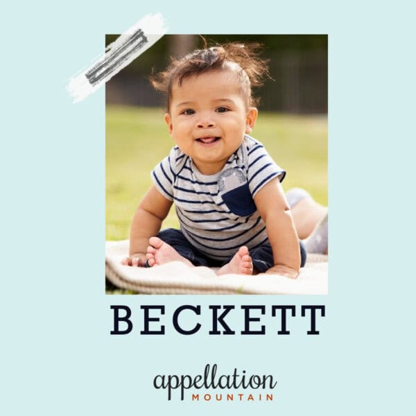 boy child with wispy dark hair wearing navy and white striped top sitting outside on a blanket; baby name Beckett