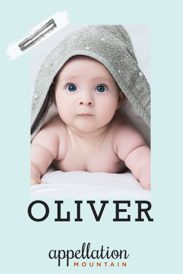 blue eyed baby resting on his arms, covered by gray towel; baby name Oliver