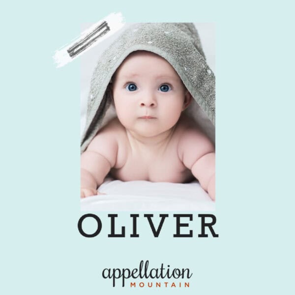 blue eyed baby resting on his arms, covered by gray towel; baby name Oliver