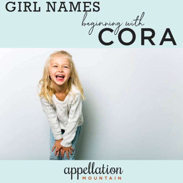 blonde girl wearing long sleeved white tee shirt, smiling and laughing "Cora names"