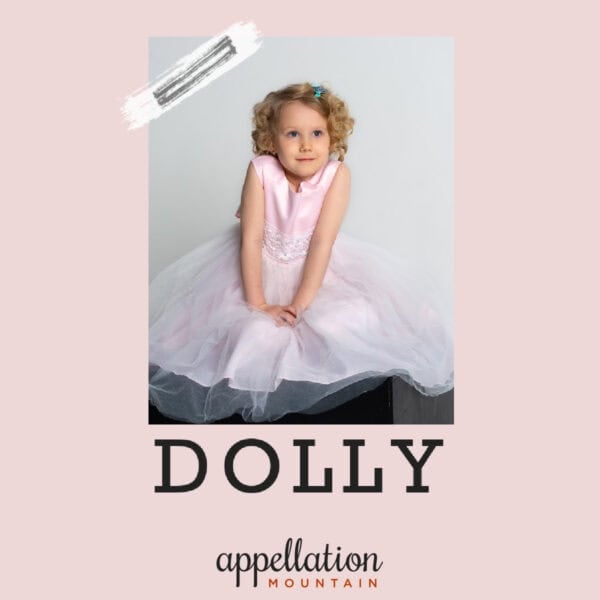 girl child with blonde curls wearing a light pink dress; baby name Dolly