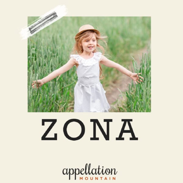 girl child with blonde hair wearing white dress and straw hat with arms extended standing in field; baby name Zona