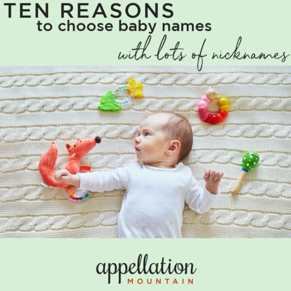 baby wearing white long sleeved onesie lying on ivory cable knit blanket surrounded by toys; names with lots of nicknames