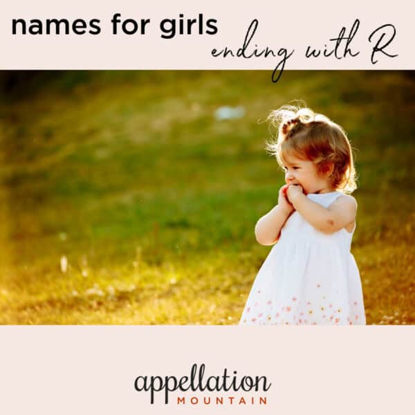 toddler girl wearing white dress standing in field; "girl names ending with R"