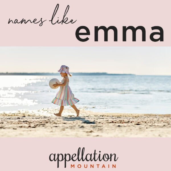 girl child walking on beach wearing striped sundress and hat holding white beach ball; "names like Emma: girl names ending in A"