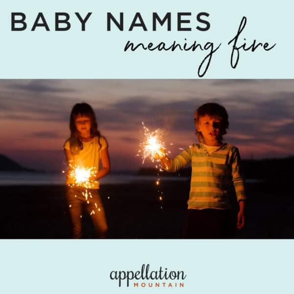 boy and girl holding fiery sparklers on the beach; baby names meaning fire