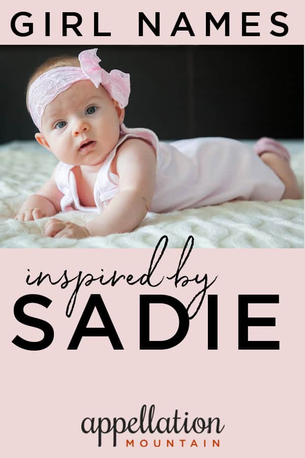 baby girl wearing pink lace bow, lying on her stomach; girl names like Sadie