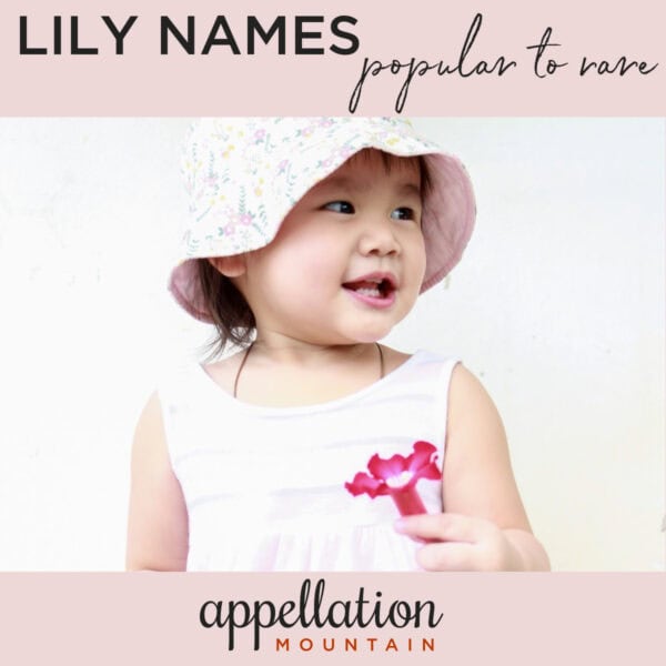 Asian toddler girl with short, dark hair wearing white hat and dress, holding bright pink lily flower "Lily Names for Girls"