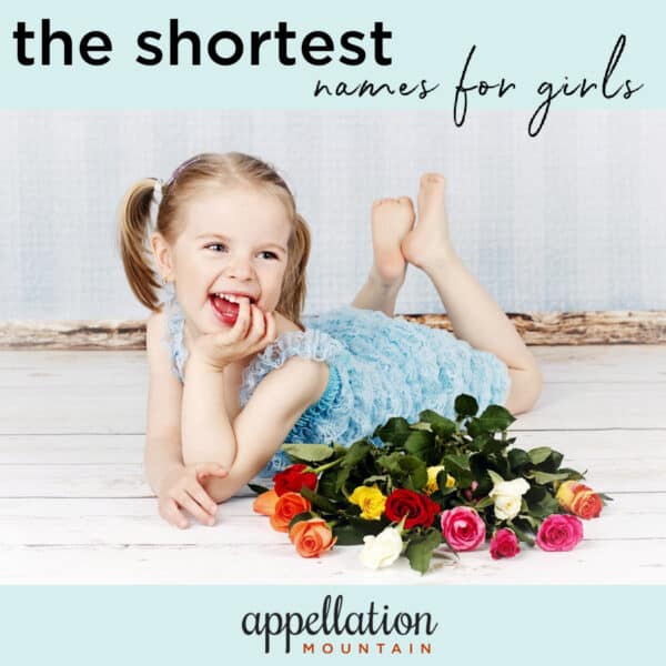 girl child in blue dress laying on floor with floral bouquet; "one syllable names for girls"