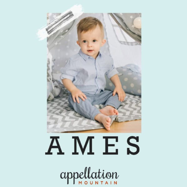 baby boy in blue button-up shirt on grey striped rug with text "Ames"