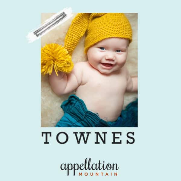 boy baby wearing yellow knit cap and blue blanket, "baby name Townes"